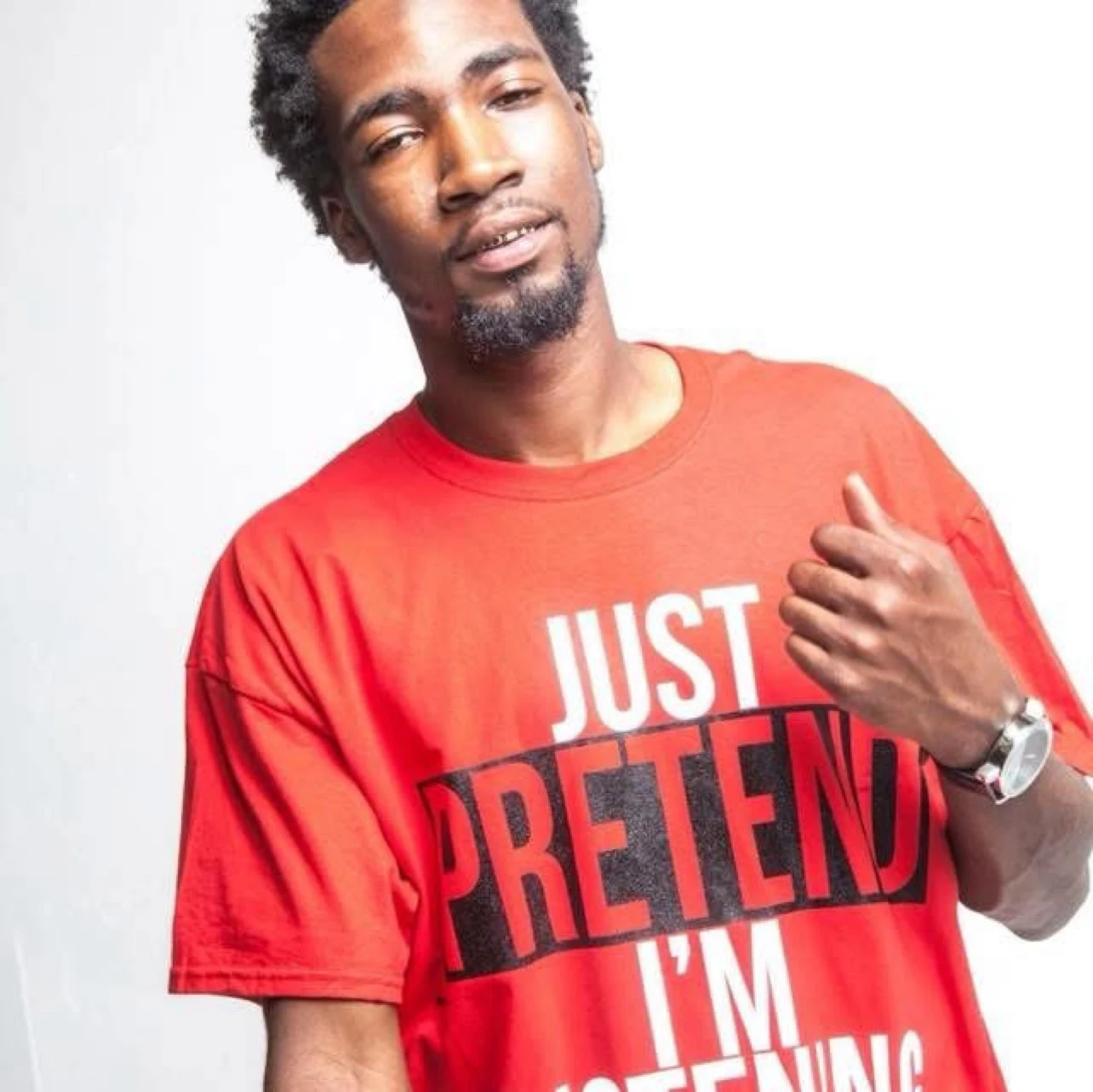 Keylo Da Beast wearing a red graphic shirt in a studio portrait