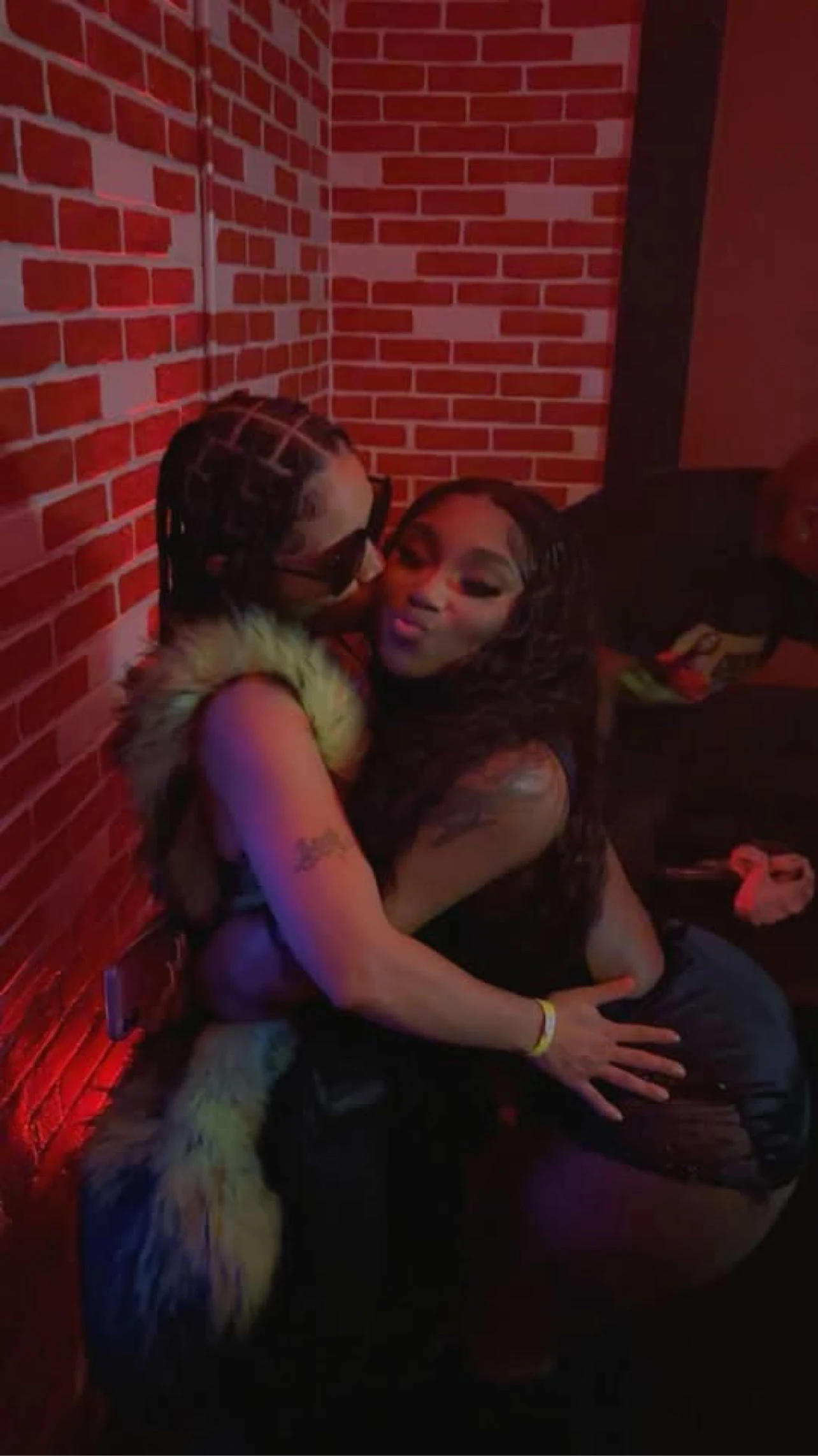 LeLe Montana embracing another guest at an event