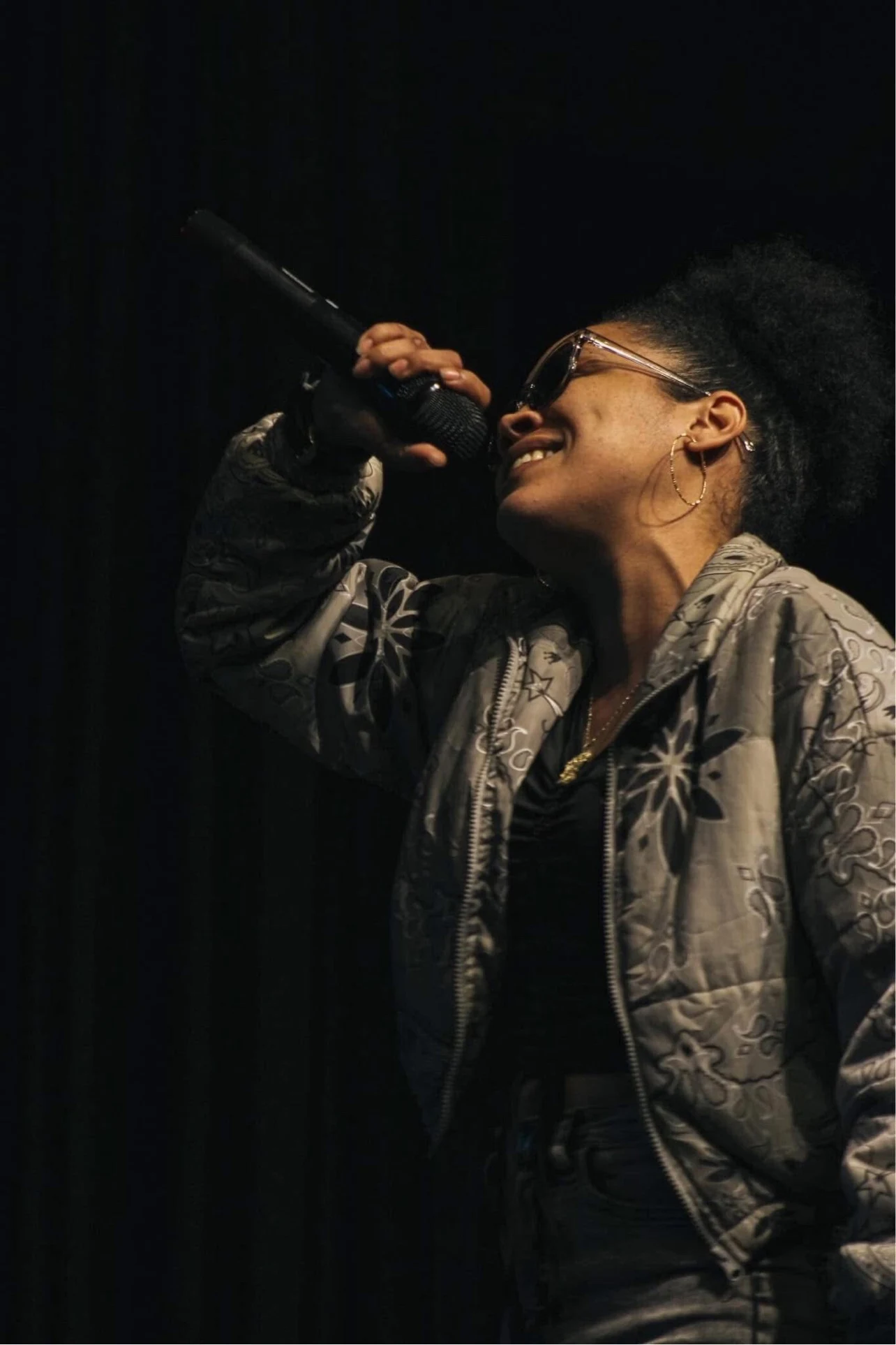 LeLe Montana performing on stage with a microphone