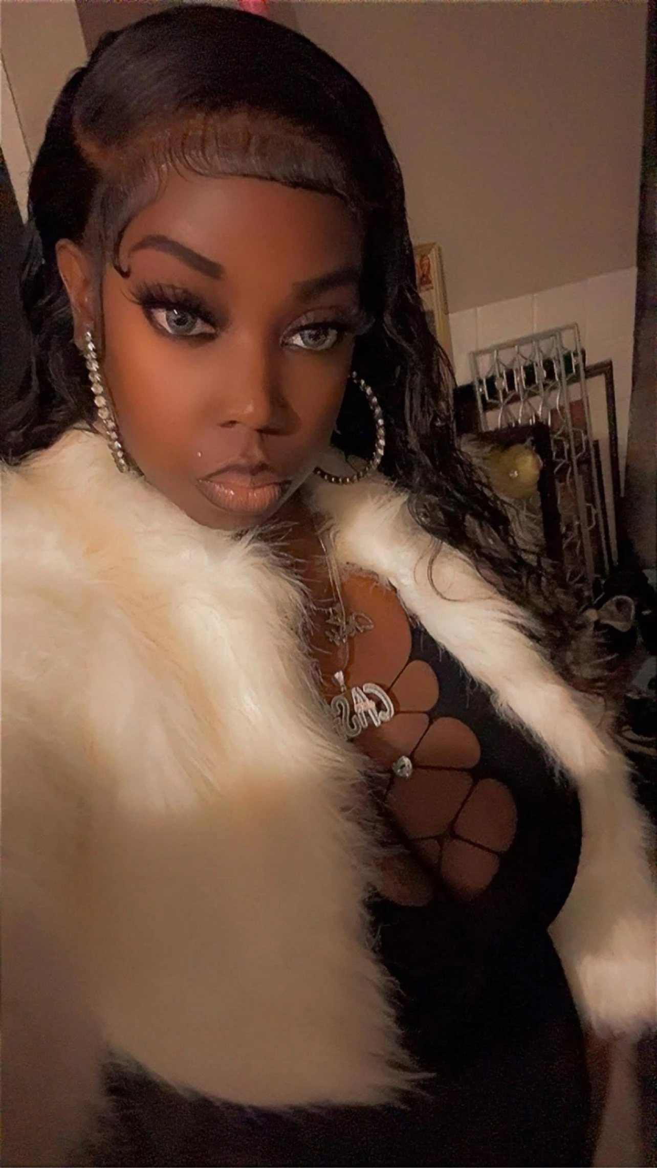 MillionDolla Ca$h wearing a white fur wrap and black outfit