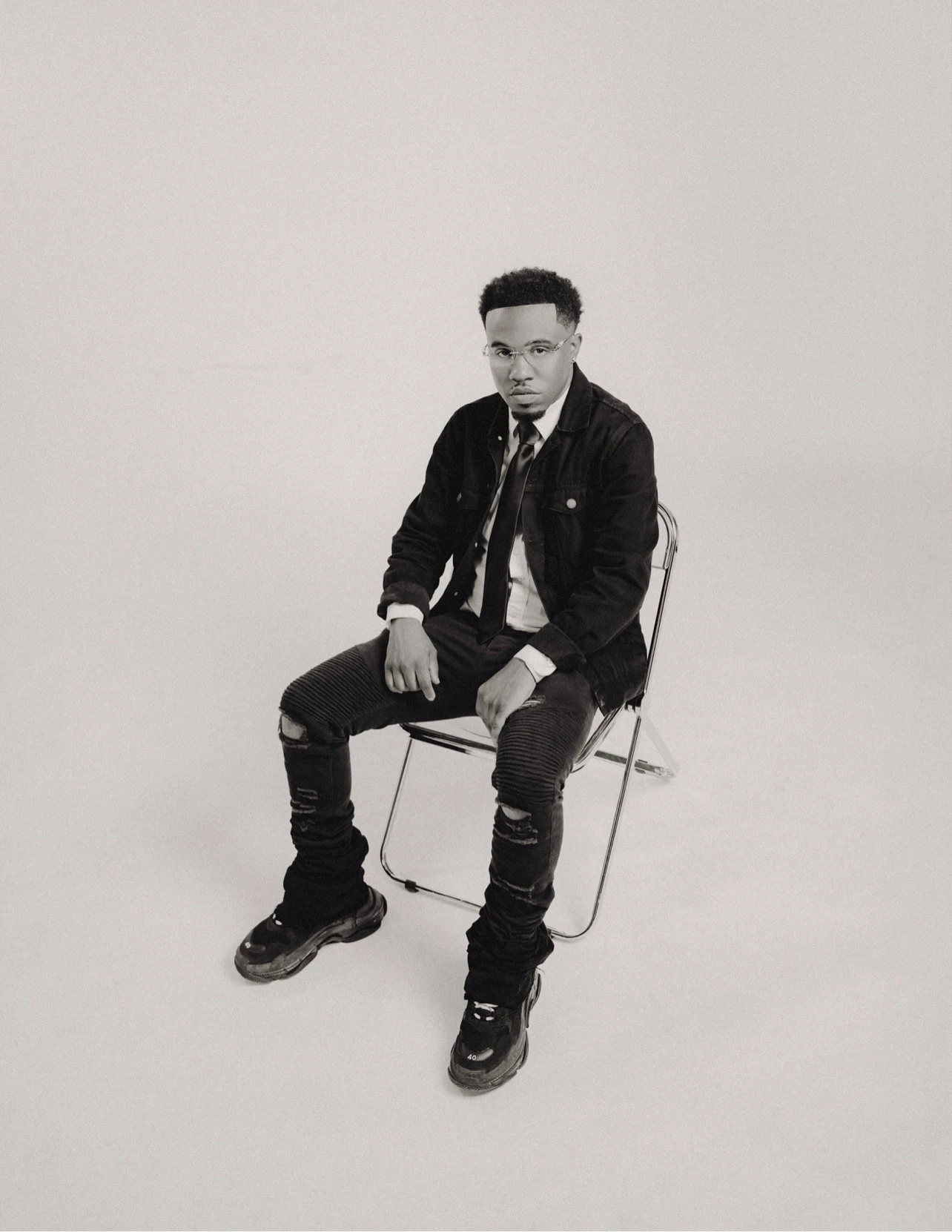 Black-and-white full-body studio portrait of oNE Nuke
