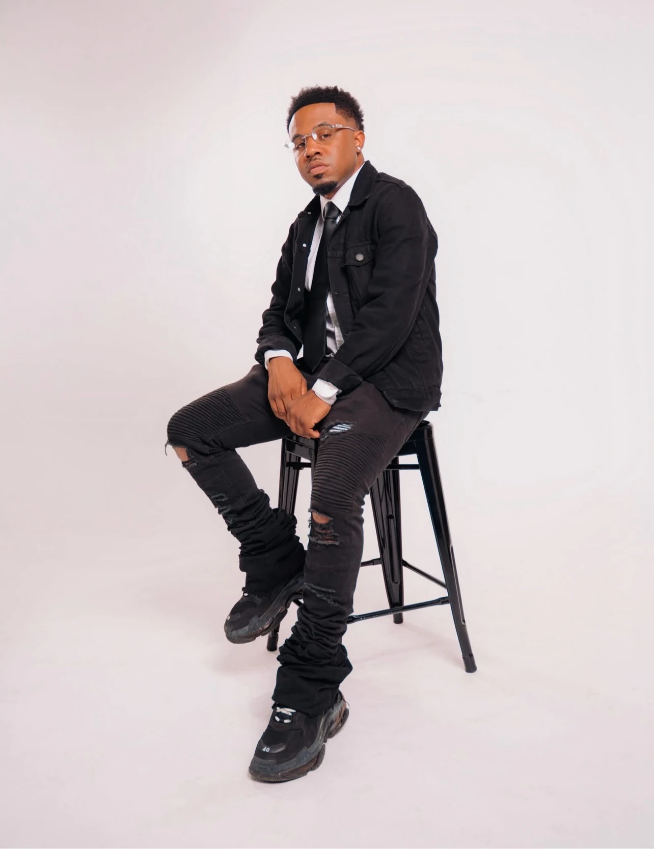 oNE Nuke seated in a full-body studio portrait