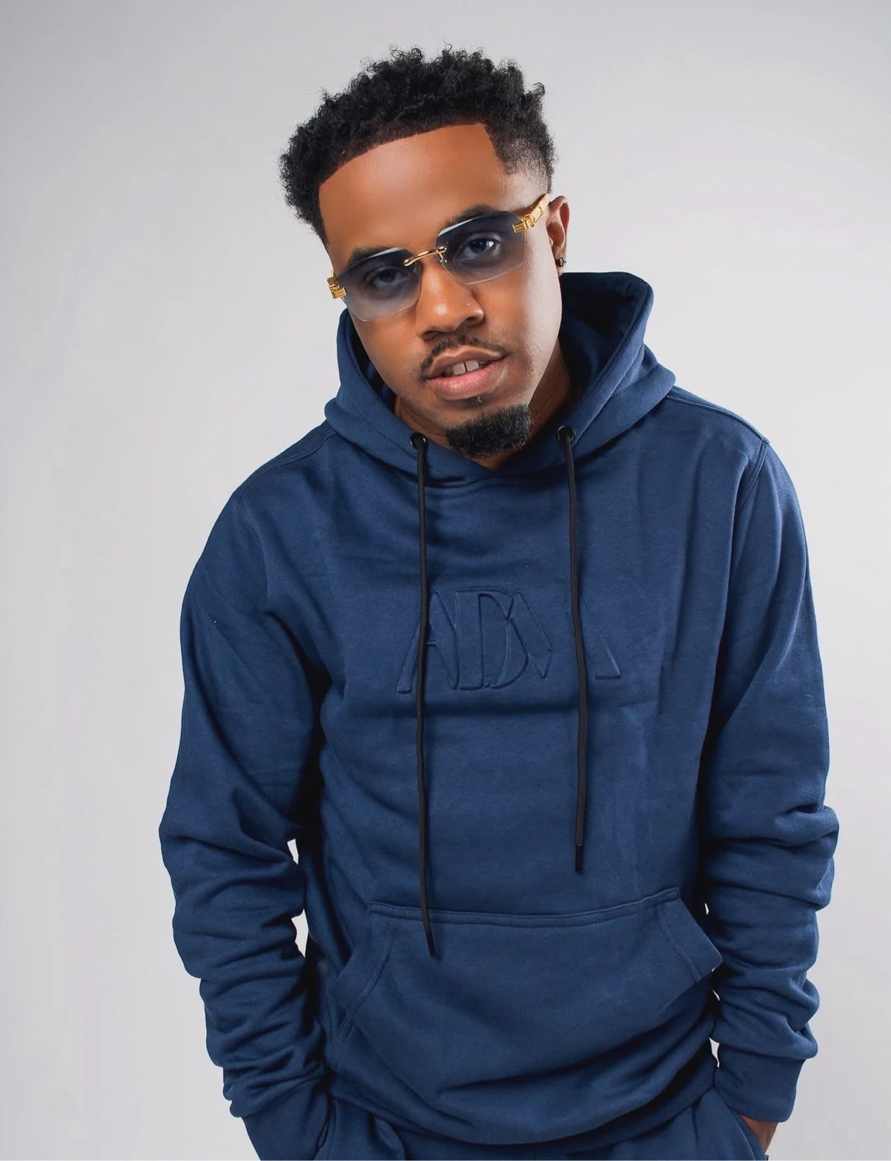 oNE Nuke wearing a navy hoodie and tinted glasses