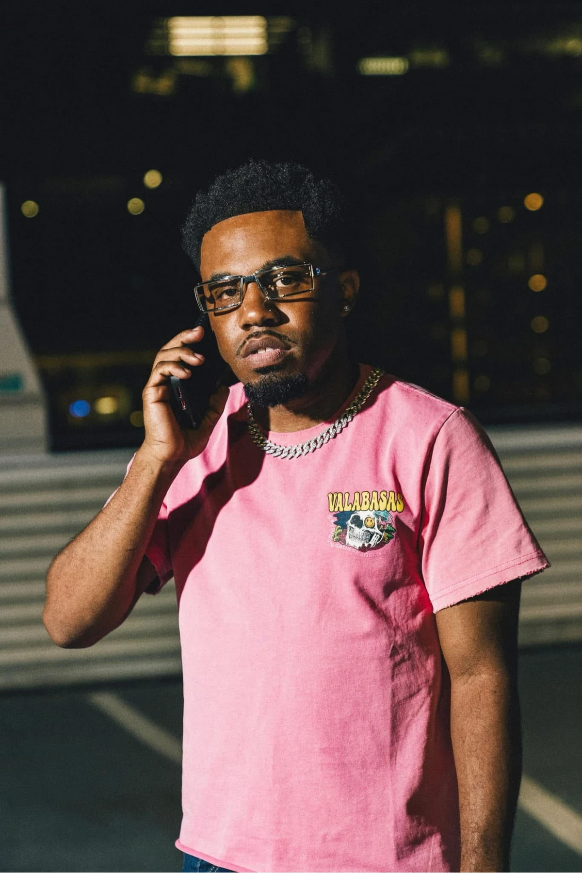 oNE Nuke wearing a pink T-shirt during an outdoor nighttime portrait session